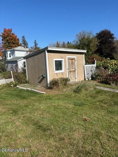 view of outdoor structure with a lawn