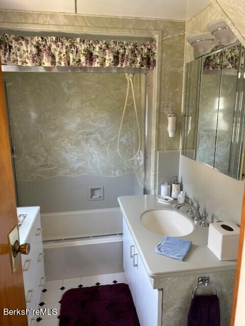 bathroom with bathtub / shower combination, vanity, and tile patterned floors