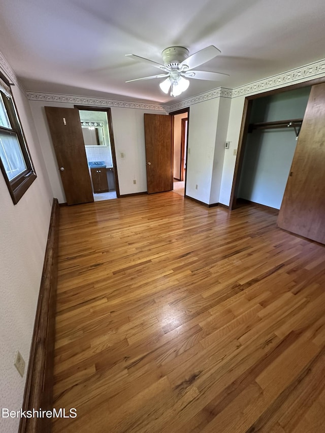 31 Autumn Dr, North Adams, MA 01247 - unfurnished bedroom with wood finished floors, ceiling fan, a closet, and multiple windows