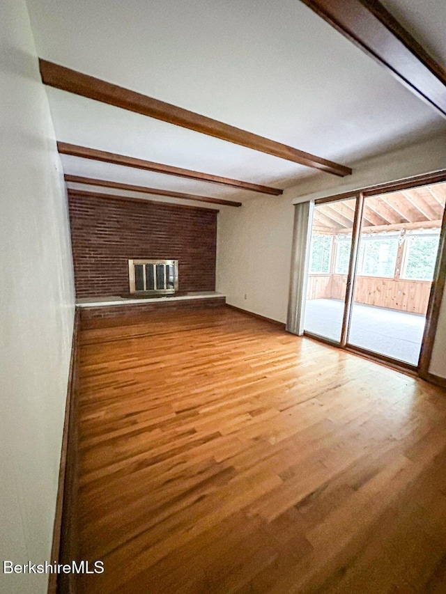31 Autumn Dr, North Adams, MA 01247 - unfurnished living room with beam ceiling, light wood finished floors, and a brick fireplace