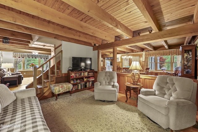 135 E St, Lee, MA 01238 - living room with a chandelier, healthy amount of natural light, stairs, a wood ceiling with exposed beams, and wooden walls