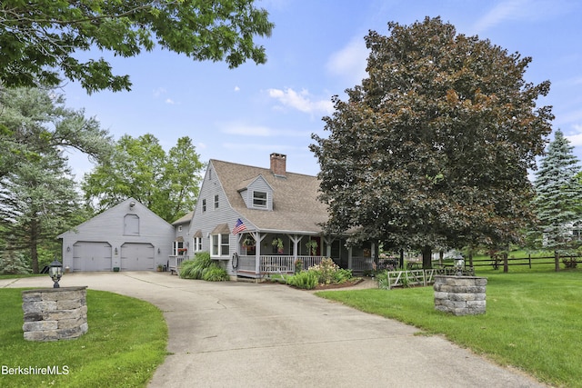 135 E St, Lee, MA 01238 - cape cod-style house featuring covered porch, a garage, a front yard, a chimney, and an outbuilding