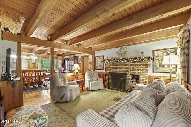 135 E St, Lee, MA 01238 - living room featuring a chandelier, a brick fireplace, a wood ceiling with exposed beams, and wood finished floors