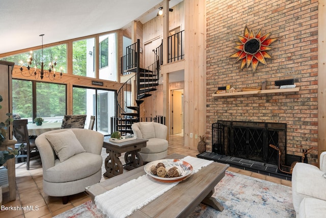 454 Seneca Dr, Becket, MA 01223 - living area featuring a high ceiling, tile patterned floors, stairs, a chandelier, and a fireplace