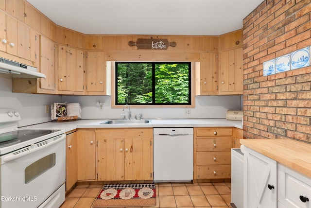 454 Seneca Dr, Becket, MA 01223 - kitchen with white appliances, under cabinet range hood, brick wall, and light tile patterned floors