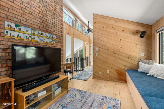 454 Seneca Dr, Becket, MA 01223 - living area featuring hardwood / wood-style floors, healthy amount of natural light, and wood walls