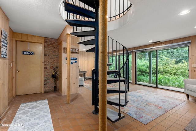 454 Seneca Dr, Becket, MA 01223 - stairs with wooden walls and tile patterned floors
