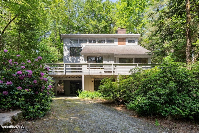 454 Seneca Dr, Becket, MA 01223 - view of front of house featuring a chimney, a wooden deck, and a shingled roof