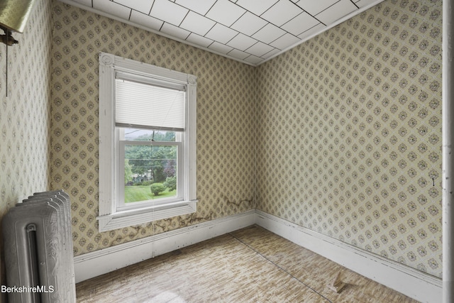 34-36 Crandall St, Adams, MA 01220 - spare room with radiator heating unit and wallpapered walls