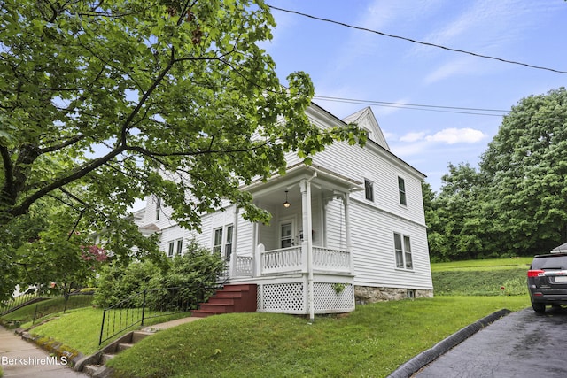 34-36 Crandall St, Adams, MA 01220 - traditional style home featuring covered porch and a front lawn