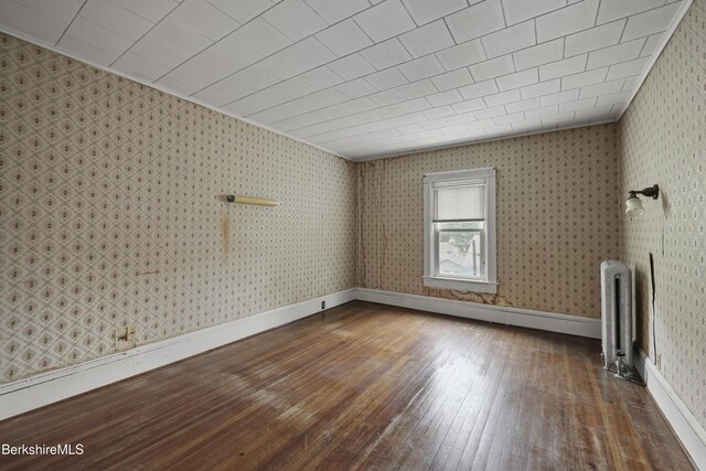 34-36 Crandall St, Adams, MA 01220 - empty room with hardwood / wood-style floors, radiator, and wallpapered walls