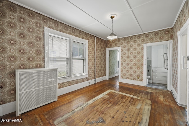 34-36 Crandall St, Adams, MA 01220 - unfurnished dining area featuring radiator heating unit, hardwood / wood-style floors, wallpapered walls, and crown molding