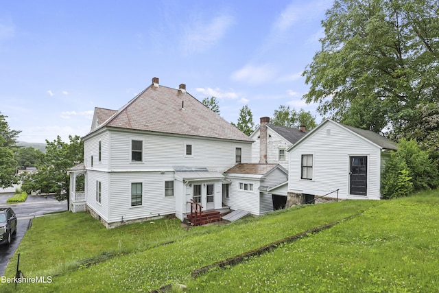 34-36 Crandall St, Adams, MA 01220 - rear view of property featuring a lawn and a chimney