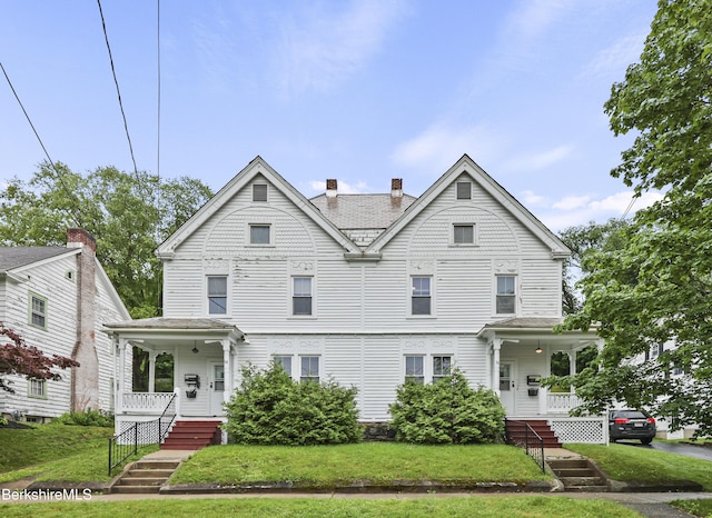 34-36 Crandall St, Adams, MA 01220 - victorian home featuring covered porch, a chimney, and a front yard
