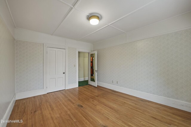 34-36 Crandall St, Adams, MA 01220 - unfurnished bedroom with hardwood / wood-style floors, wallpapered walls, and a closet