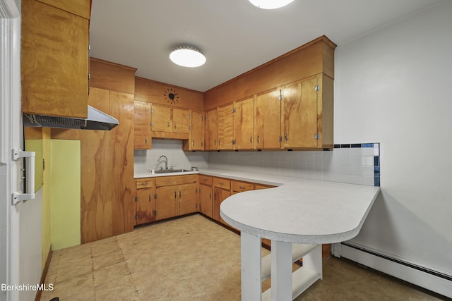 34-36 Crandall St, Adams, MA 01220 - kitchen with baseboard heating, light countertops, tasteful backsplash, brown cabinets, and a peninsula