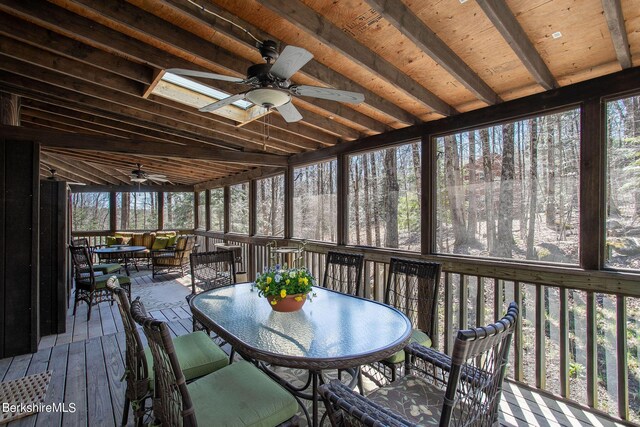 unfurnished sunroom featuring ceiling fan