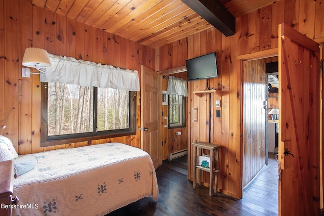 bedroom with wood walls, wooden ceiling, dark wood-type flooring, baseboard heating, and beamed ceiling