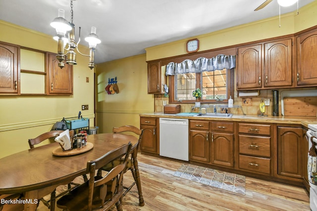 110 Maple Grove Dr, Pittsfield, MA 01201 - kitchen featuring dishwasher, light countertops, light wood finished floors, brown cabinetry, and decorative light fixtures