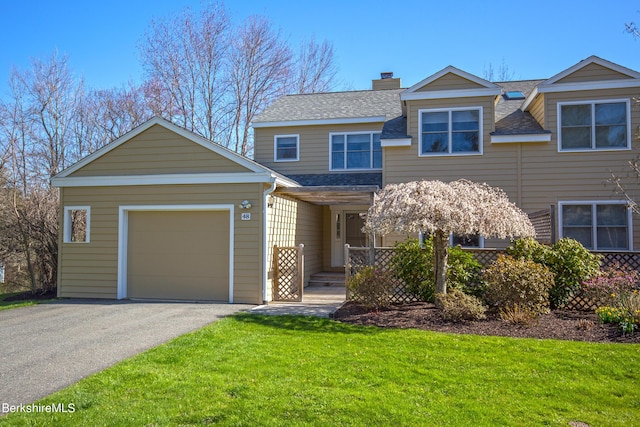 view of front facade featuring a garage and a front lawn