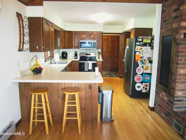 805 Savoy Rd, Cheshire, MA 01225 - kitchen featuring stainless steel appliances, light wood finished floors, baseboard heating, a peninsula, and light countertops