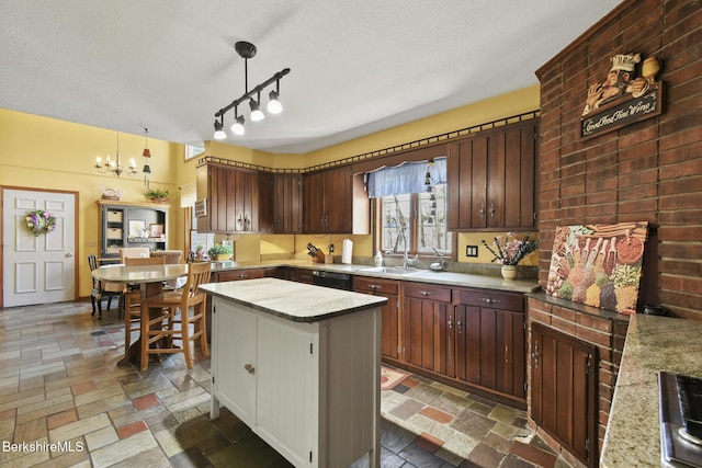 131 Wilshire Dr, Cheshire, MA 01225 - kitchen with an inviting chandelier, a textured ceiling, stone tile floors, light countertops, and a sink