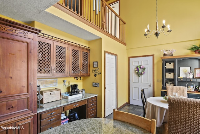131 Wilshire Dr, Cheshire, MA 01225 - interior space featuring stone counters, baseboards, an inviting chandelier, a high ceiling, and stone finish flooring