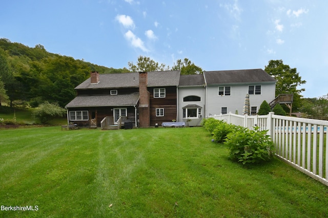 131 Wilshire Dr, Cheshire, MA 01225 - rear view of property featuring a yard, fence, and a chimney