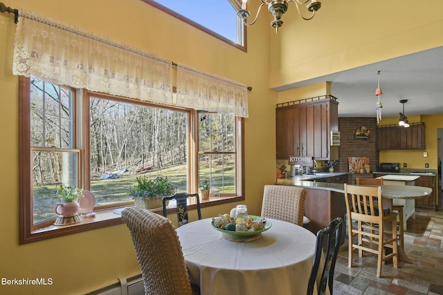 131 Wilshire Dr, Cheshire, MA 01225 - dining space featuring stone finish floor and an inviting chandelier