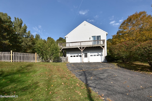131 Wilshire Dr, Cheshire, MA 01225 - view of side of property featuring an attached garage, fence, a lawn, and aphalt driveway