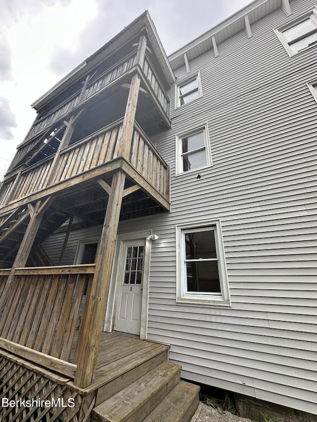 view of exterior entry featuring a balcony