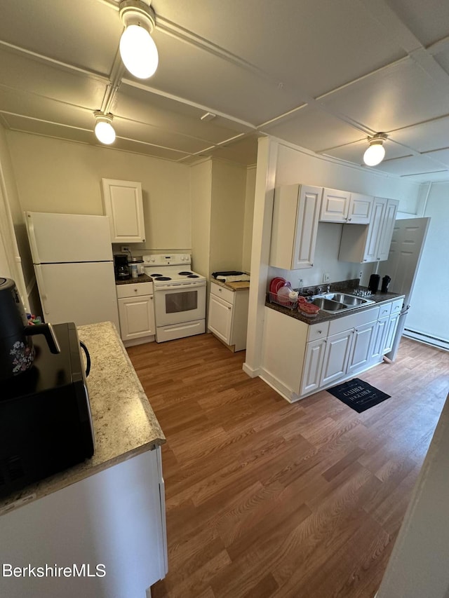 kitchen with white appliances, light hardwood / wood-style flooring, white cabinetry, and sink