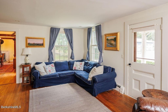 living room featuring hardwood / wood-style floors and a baseboard heating unit