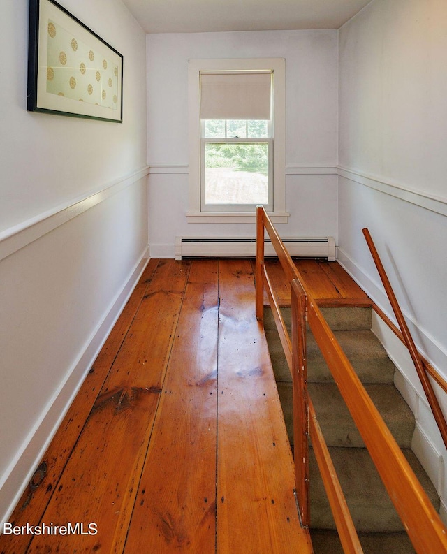 interior space featuring wood-type flooring and baseboard heating