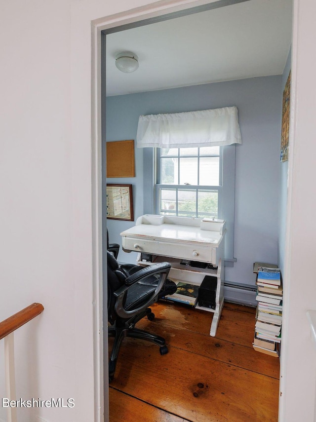 home office with hardwood / wood-style floors and a baseboard radiator