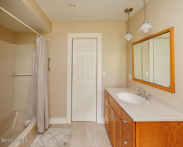 bathroom with shower / bathtub combination with curtain and vanity