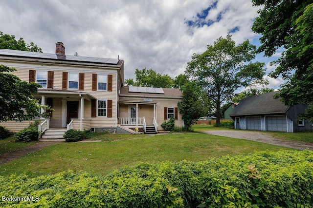 view of front of home with a porch, solar panels, and a front lawn