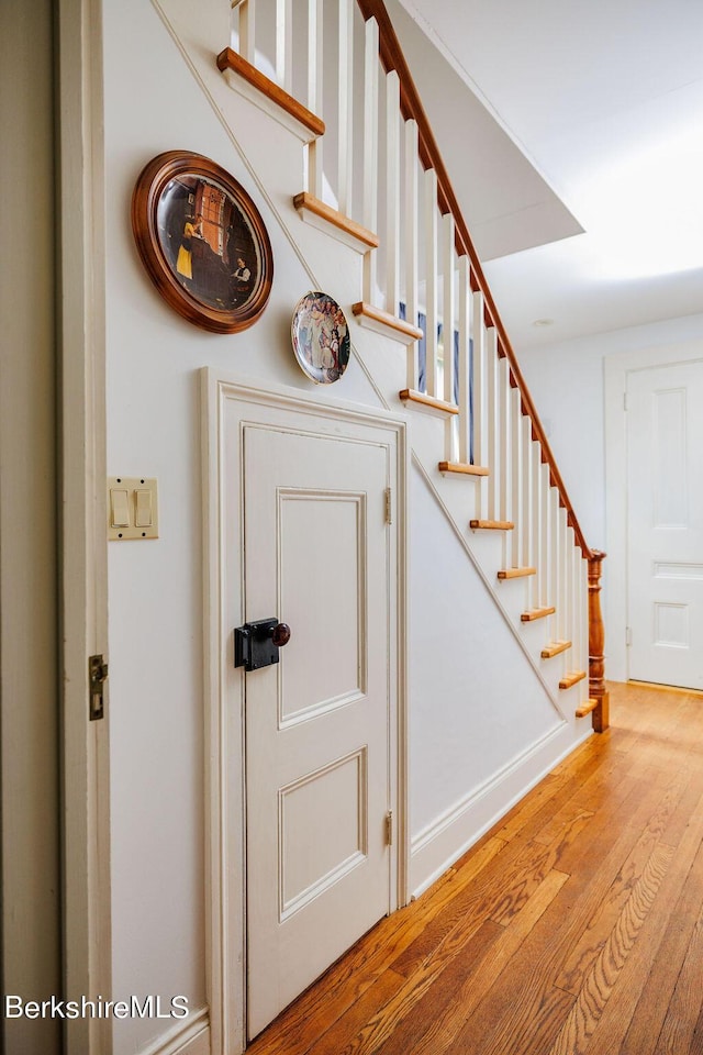 stairs featuring wood-type flooring