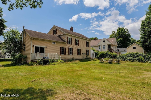 rear view of property featuring a yard