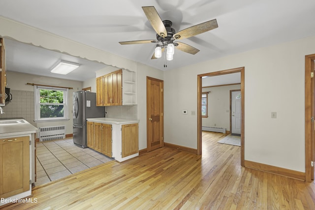 127 Gamwell Ave, Pittsfield, MA 01201 - kitchen featuring radiator, a baseboard heating unit, freestanding refrigerator, open shelves, and light countertops