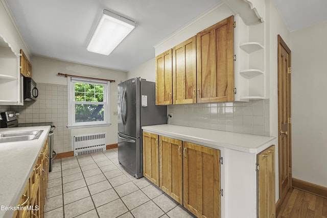127 Gamwell Ave, Pittsfield, MA 01201 - kitchen featuring open shelves, radiator heating unit, black microwave, freestanding refrigerator, and light countertops