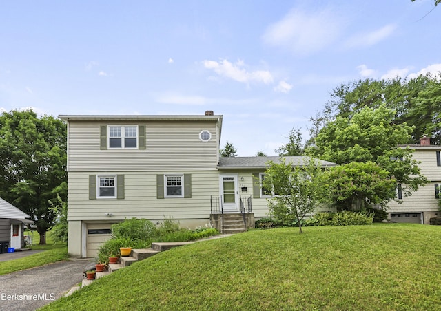 127 Gamwell Ave, Pittsfield, MA 01201 - view of front of home featuring a garage, a front lawn, asphalt driveway, and a chimney