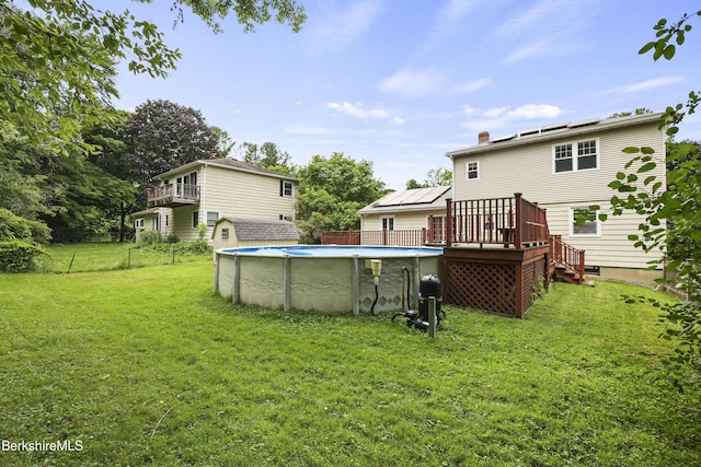 127 Gamwell Ave, Pittsfield, MA 01201 - rear view of property featuring a wooden deck, an outdoor pool, and a chimney