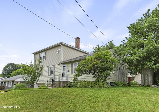 127 Gamwell Ave, Pittsfield, MA 01201 - back of property with a chimney, a storage shed, and a lawn