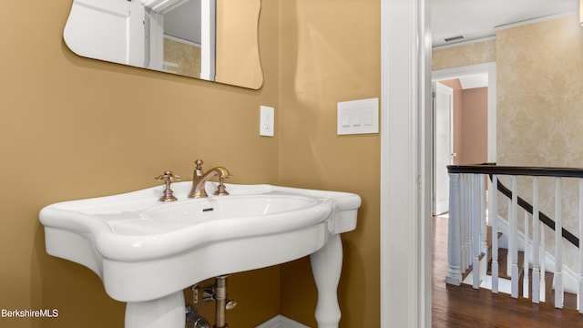 bathroom with a sink, visible vents, and wood finished floors