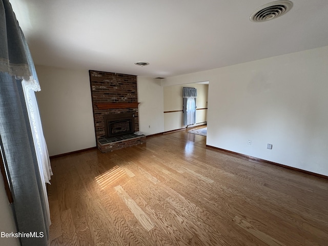 184 Mcintosh Dr, Pittsfield, MA 01201 - unfurnished living room with wood finished floors and a fireplace
