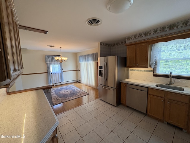 184 Mcintosh Dr, Pittsfield, MA 01201 - kitchen with appliances with stainless steel finishes, a chandelier, plenty of natural light, and light tile patterned floors