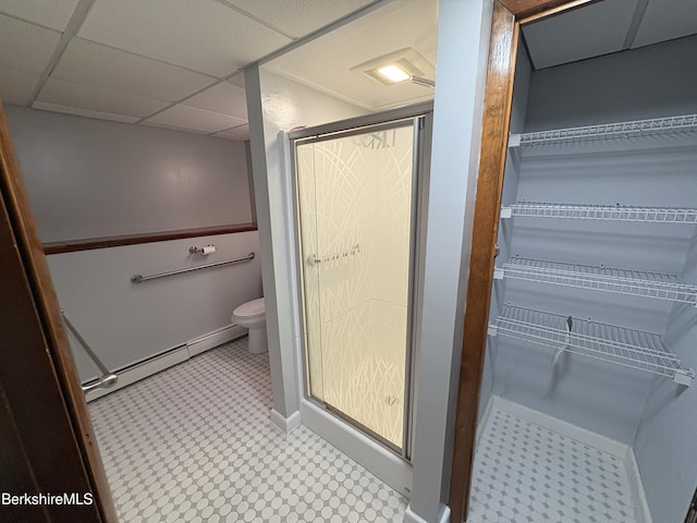 184 Mcintosh Dr, Pittsfield, MA 01201 - bathroom with a baseboard radiator, a shower stall, a spacious closet, and a drop ceiling