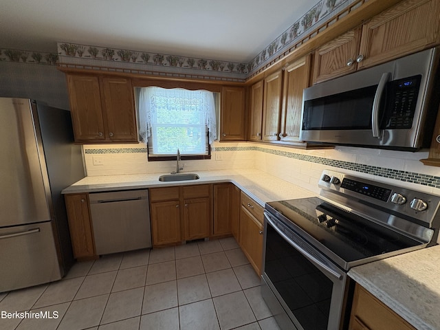 184 Mcintosh Dr, Pittsfield, MA 01201 - kitchen with appliances with stainless steel finishes, light tile patterned flooring, light countertops, and tasteful backsplash