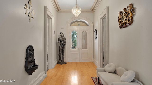 6 Eileen Dr, Rensselaer, NY 12144 - foyer entrance featuring a chandelier, baseboards, light wood-style floors, and ornamental molding